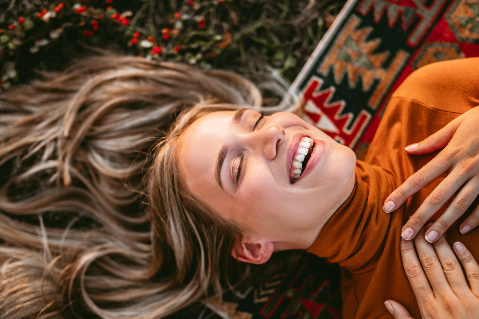 Woman relaxing, lying down on the meadow